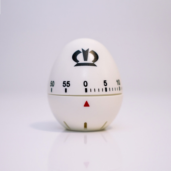 White egg‑shaped kitchen timer with black dial markings on white background