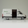 Miniature service van featuring black trim and rolling wheels on white background