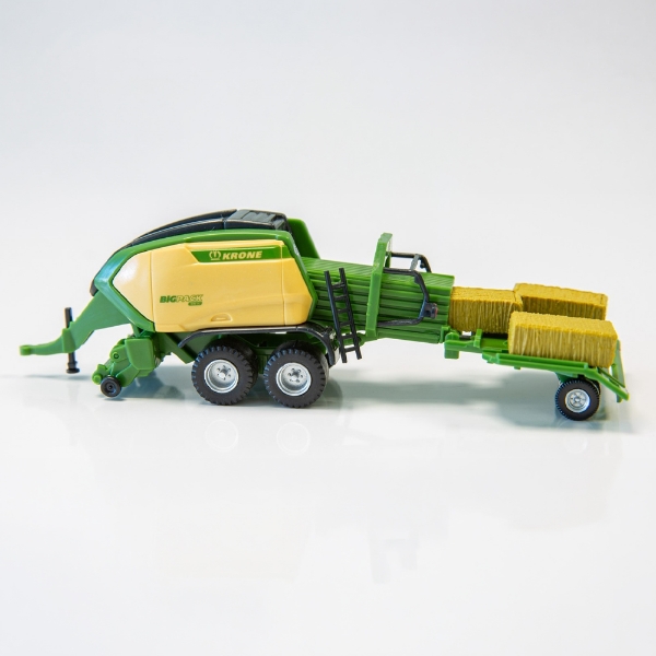 1:87 scale baler model with BaleCollect system and molded bales on white background