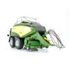 Rear angled view of baler model showing hitch, hydraulic connections, and dual wheel setup
