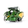 Rear angled view of baler model with open top panel showing internal chamber detail, PTO shaft, pickup assembly, and hydraulic hoses