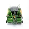 Rear view of baler model centered on pickup assembly, PTO shaft, and grouped hydraulic hoses extending from the hitch