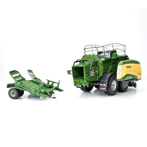 Rear angled view of baler model with BaleCollect trailer detached showing bale chamber opening and trailer platform detail