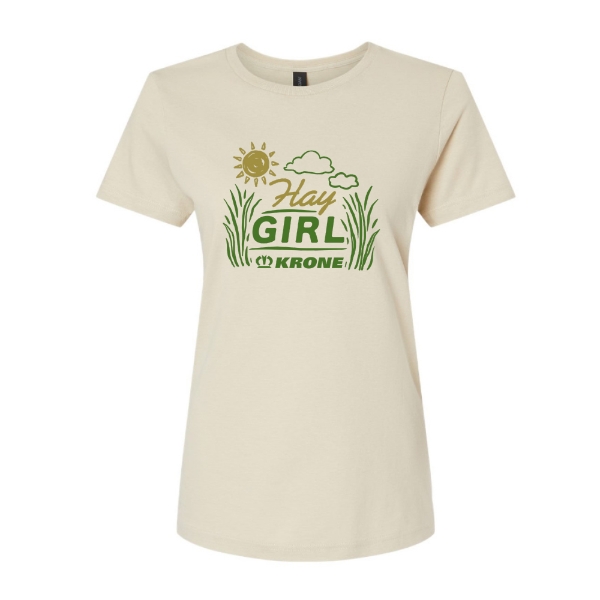 Cream women’s t‑shirt with “Hay Girl” farm graphic featuring sun, clouds, grass, and green Krone logo centered on front